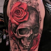 Half 3D half dot style colored shoulder tattoo of human skeleton stylized with flowers