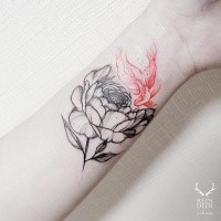 Half colored nice looking painted by Zihwa tattoo of flower with red leaf