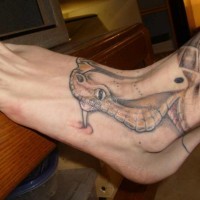 Head of snake tattoo on foot