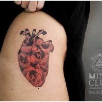 Heart of red roses tattoo on thigh