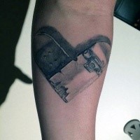 Heart shaped broken skateboard tattoo on forearm in realism style