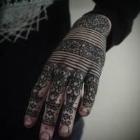 Henna style black ink hand tattoo of identic tribal ornaments and lines
