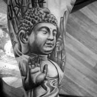 Hinduism style black ink arm tattoo of Buddha statue with jungle