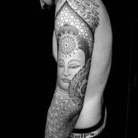 Hinduism style black ink sleeve tattoo of Buddha face and ornaments