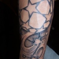 Homemade black and white football tattoo on arm with stars