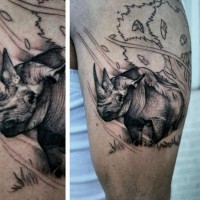 Homemade black and white shoulder tattoo of small rhino in wild life