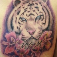 Homemade carelessly painted colored tiger head tattoo with flowers and lettering