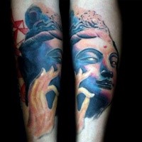 Homemade colored forearm tattoo of Buddha statue