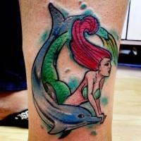 Homemade colorful carelessly painted leg tattoo of mermaid with dolphin