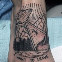 Homemade like black ink alien ship with human and lettering tattoo on foot