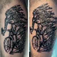 Homemade like black ink bicycle rider with lettering tattoo on leg