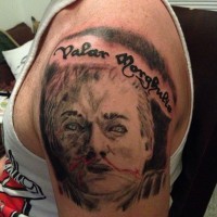 Homemade like colored Game of Thrones hero portrait tattoo on shoulder with lettering