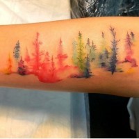 Homemade like multicolored abstract trees tattoo on arm