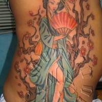Homemade like painted colored seductive geisha tattoo on side with blooming tree