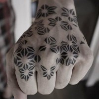 Homemade style black ink tribal ornaments tattoo on hand