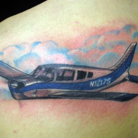 Homemade style colored upper back tattoo of big plane