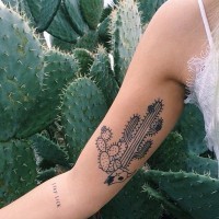 Homemade style painted black ink cactus with animal skull tattoo on arm