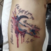 Homemade watercolor style big moon tattoo on side stylized with lettering