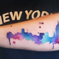 Homemade watercolor style colored forearm tattoo of big city sights