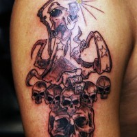 Horrible grim reaper with skulls tattoo on shoulder