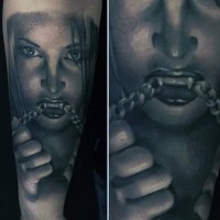 Horrifying painted black and white vampire woman with chain tattoo on sleeve