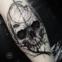 Horror blackwork style leg tattoo of vampire skull with tree branch