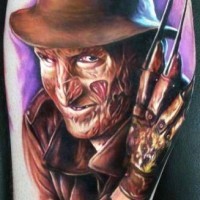 Horror movie Freddy Krueger colored portrait tattoo on leg