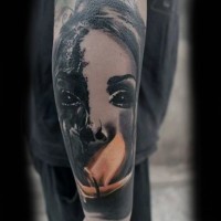 Horror movie like black ink demonic woman face tattoo of forearm combined with flames