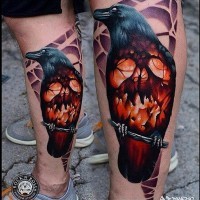 Horror movie like colored big crow stylized with burning skull tattoo on leg