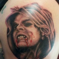 Horror movie like colored bloody vampire tattoo on shoulder