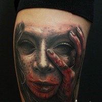 Horror movie like colored very detailed arm tattoo of bloody demonic woman portrait