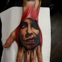 Horror movie style colored evil bloody vampire tattoo on hand