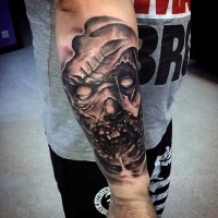Horror style black and white forearm tattoo of monster face