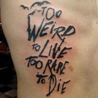 Horror style black ink big lettering tattoo on side with bats