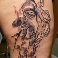Horror style black ink thigh tattoo of woman face with smoke