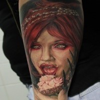 Horror style colored arm tattoo of creepy woman face with cup cake