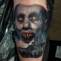 Horror style colored arm tattoo of vampire face with old house