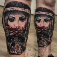 Horror style colored leg tattoo of demonic woman face with skull