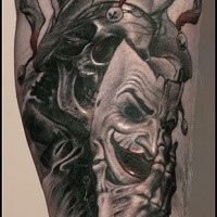 Horror style colored leg tattoo of Joker skeleton with mask