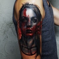 Horror style colored shoulder tattoo of woman face with blood