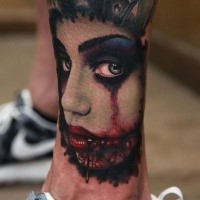 Horror style creepy looking arm tattoo of bloody monster woman