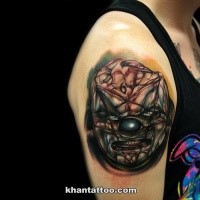 Horror style creepy looking shoulder tattoo of demonic clown face
