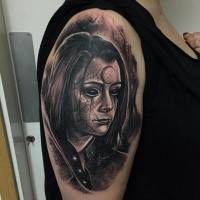 Horror style dark colored young girl's portrait with mystique symbol and veins on face shoulder tattoo