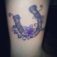 Horseshoe with purple flowers tattoo