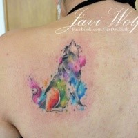 Howling wolf colored tattoo on back by Javi Wolf in watercolor style