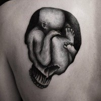 Human skull shaped black ink scapular tattoo stylized with little baby