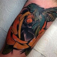 Hummingbird and rose flower colored tattoo in new school style