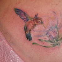 Paint splash hummingbird and flower tattoo