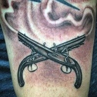 Illustrative style black ink arm tattoo of crossed antic pistols