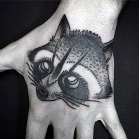 Illustrative style black ink hand tattoo of cut raccoon head